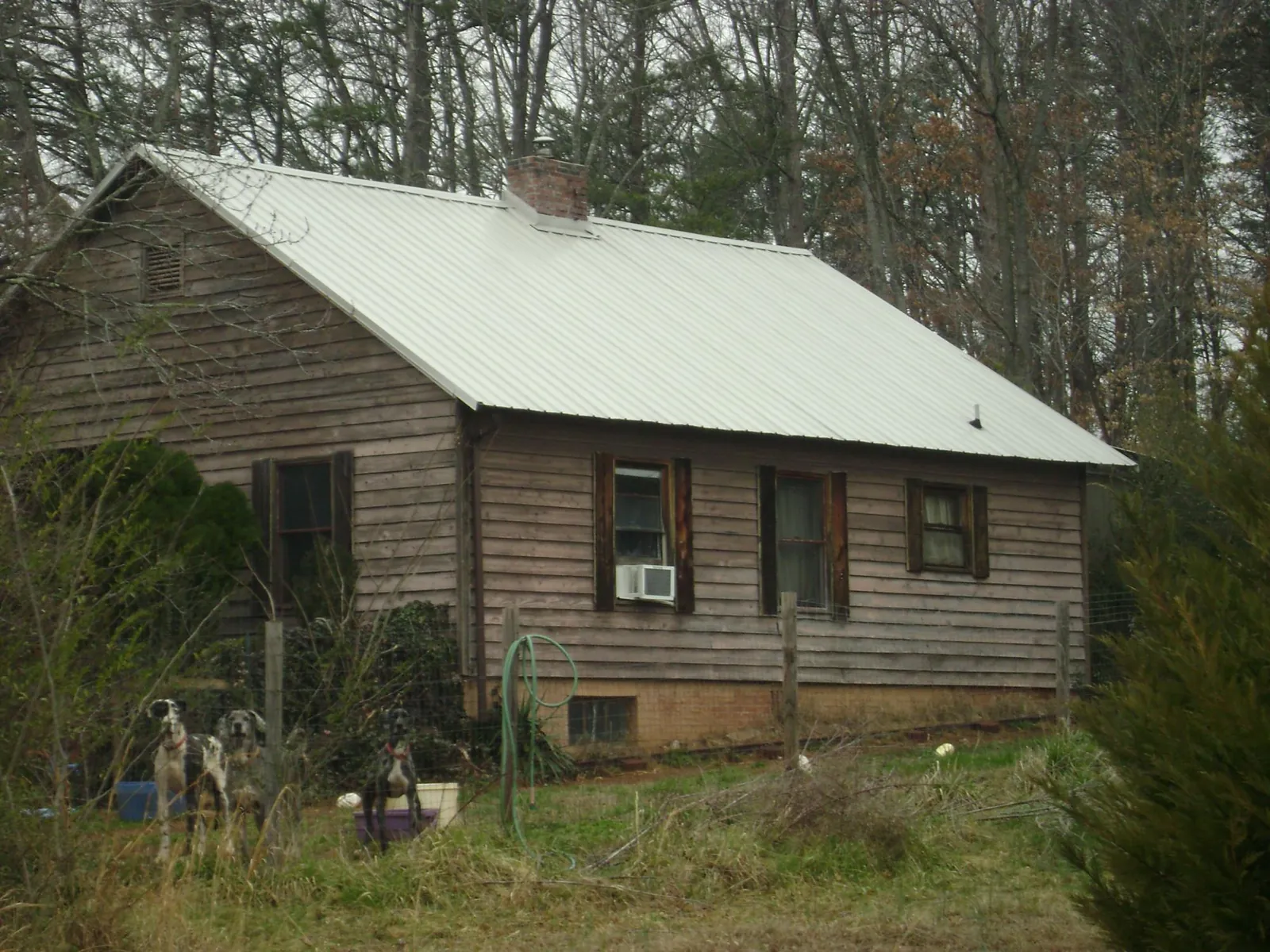 White metal roof on an old wood sided farmhouse, from a Metal Roof Installation job in Hooksett
